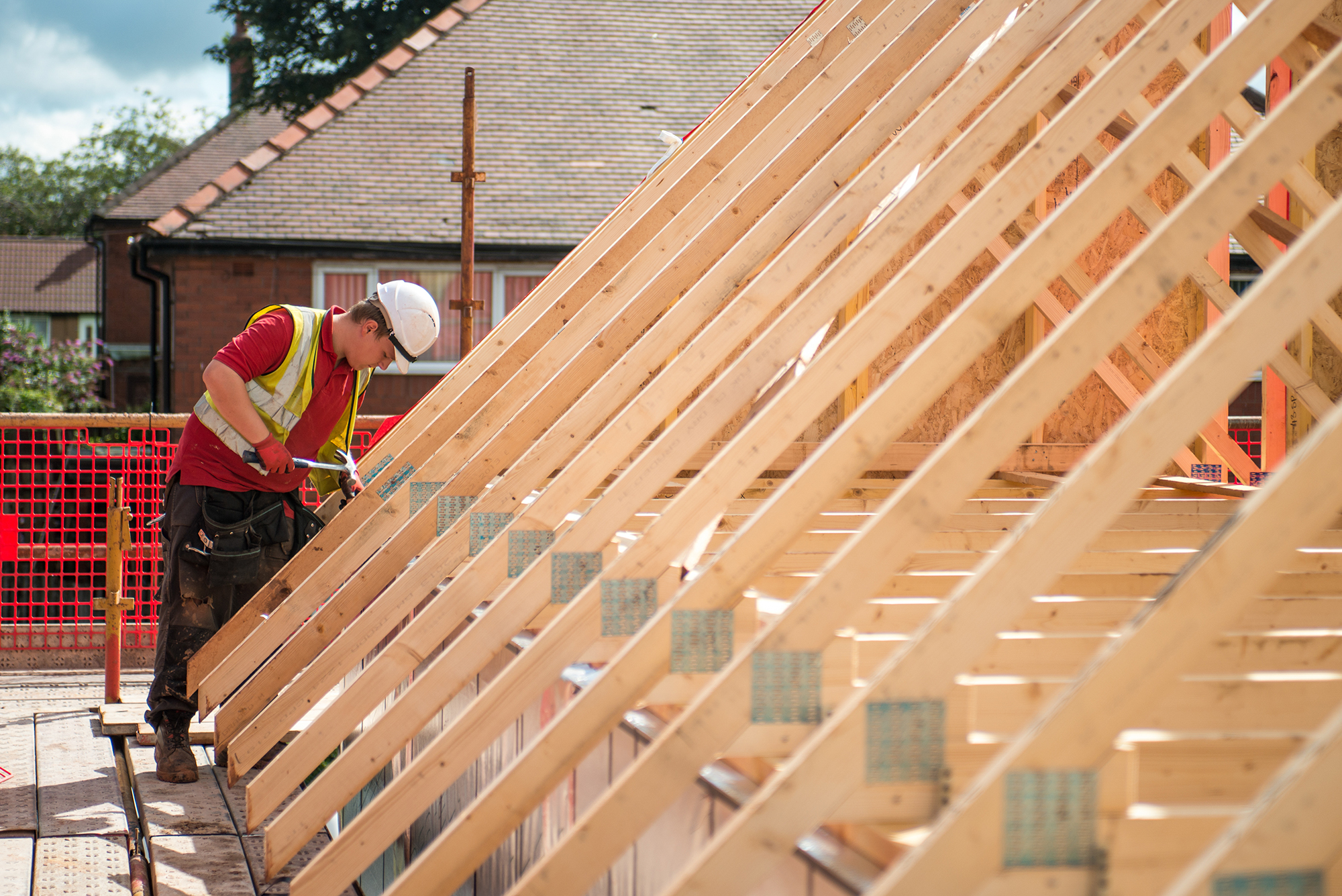 Roofer constructing new roof beams Roofer constructing new roof beams
